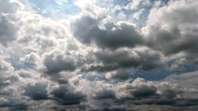 Flowing rainy clouds in the blue skies. 4K video (Ultra High Definition) of dramatic cloudscape. Sky and clouds Timelapse.