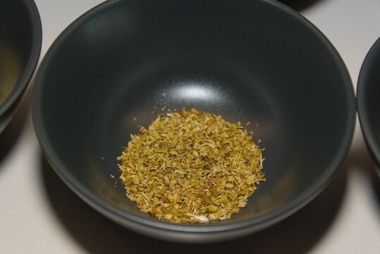 Dried Oregano Leaves in Black Ceramic Bowl