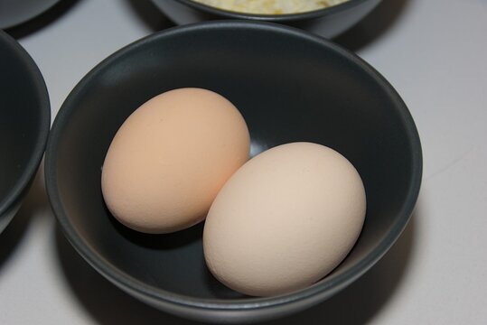 Two Brown Eggs in Black Ceramic Bowl