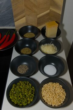Assorted Culinary Spices and Nuts in Black Ceramic Bowls