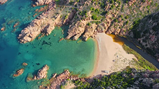 4k drone flight down footage (Ultra High Definition) of Li Cossi beach. Summer scene of Costa Paradiso, Sardinia island, Italy. Attractive Mediterranean seascape. Beauty of nature concept background.