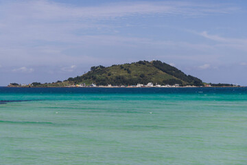 Fototapeta premium Jeju Island, Hyeopjae Beach, Hallim, white sand beach and sea, Hallim-ro, Hallim-eup, Geumneung Beach, Jeju-do, South Korea, Jeju Province, landscape view in a sunny day, and Biyangdo island