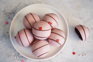 Chocolate Cake balls covered in pink icing | Valentines day sweets, selective focus