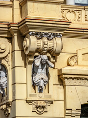 Ornate Classical Sculpture Niche on Historic Town Hall Building with Carved Capitals and Decorative Frieze