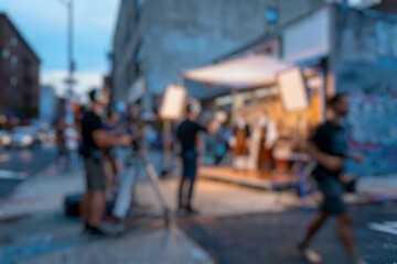 Obraz premium Blur image of The film crew is setting up equipment and shooting a film at night in an urban area.