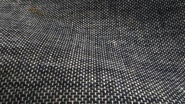 Dark gray book cloth featuring waves of texture and smooth weave