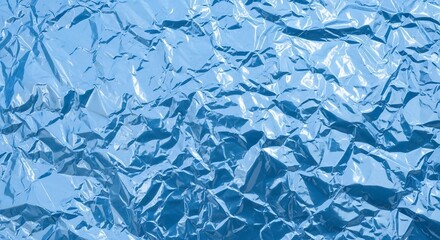 Obraz premium Crinkled blue aluminum foil texture with reflective shiny surface pattern