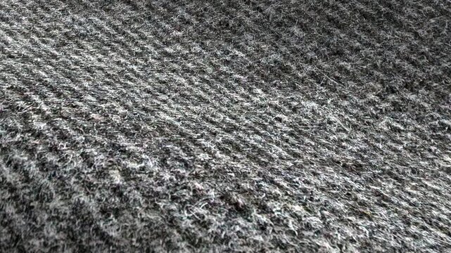 Gray fabric waves of texture with diagonal weave and carpet-like surface