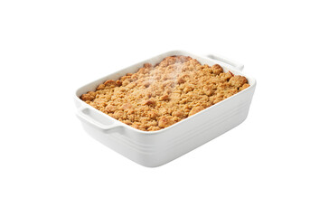 Apple crumble served in a white ceramic dish, set against a white backdrop

