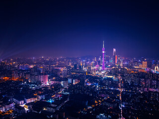 Obraz premium Aerial night view of Guangzhou: illuminated cityscape with tower and skyscrapers of China