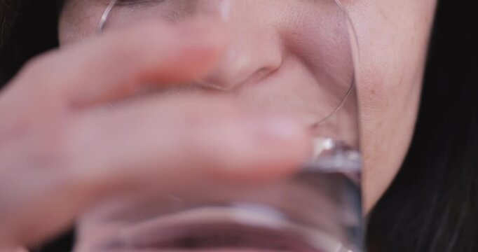 Adult woman taking a pill, symbolizing health, self-care, wellness, and dietary supplements in a responsible daily routine.