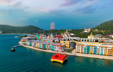 Vibrant coastal theme park with colorful buildings and ferris wheel at sunset Nha trang, Vietnam © Parilov
