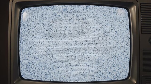 Retro Analog TV Static - A vintage television displays a static screen with horizontal lines and a distorted checkered pattern. The screen shows a rewind signal-like glitch effect.