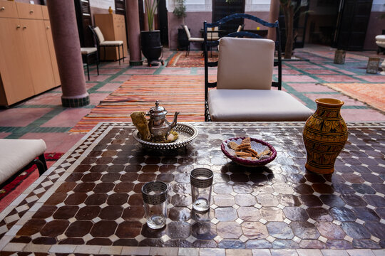 Teapot with cookies,traditional mint tea in moroccan house 
Offering mint tea is a tradition that means hospitality. Marrakech Medina old city. North Africa
