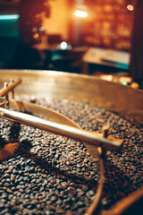 coffee beans roasting process closeup, professional roaster machinery equipment roast brown and golden colored cafe seeds close-up