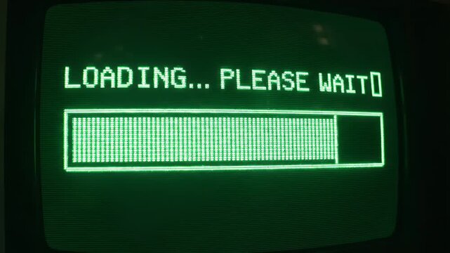 Retro Computer Loading Screen with Green Progress Bar - A retro computer screen displaying a loading message with a partially filled green pixelated progress bar. The text "LOADING...