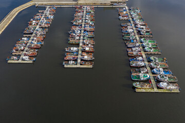 fishing boats on the pier in the port aerial view