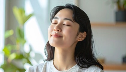 Serene Asian woman enjoying a moment of peace and relaxation.