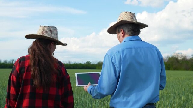 Agriculture and technology fusion, Two generations in farming, Modern farming attire, Professional farm management, Innovative countryside, Tablet-driven farm solutions, Sustainable rural development