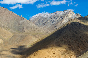 Beautiful Himalayas. Chang La , southern pass, high mountain pass in Ladakh between Leh to Pangong Lake road. On road view of shadow of cloud on Himalayan mountain. Leh, Ladakh, India. © mitrarudra