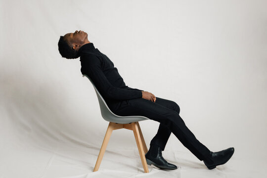 Man leaning on chair back