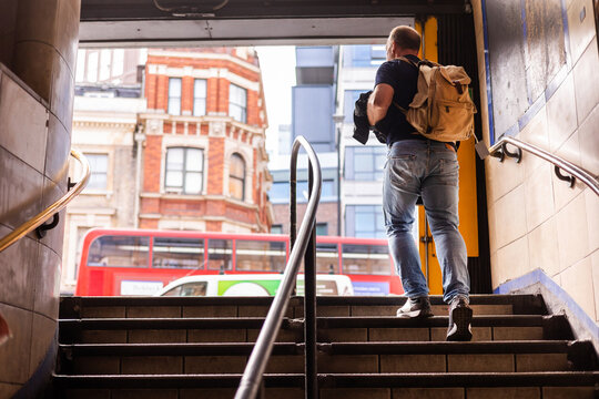 A traveler exiting the subway entrance
