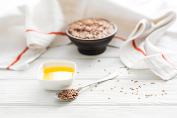 Fototapeta premium Organic linseed oil and seeds on rustic wooden surface, healthy nutrition.