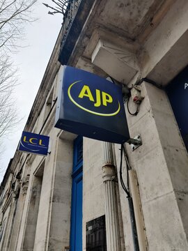 Saintes, France - January 28, 2026: AJP and LCL signage on a building exterior, showcasing modern branding in an urban setting with architectural details visible
