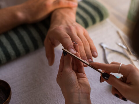 Beautician working with customer nails
