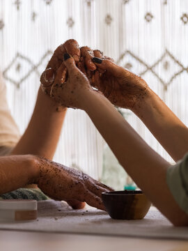Woman carefully massaging male hands 