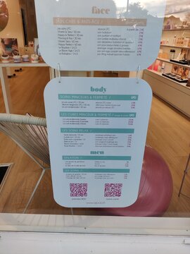 Saintes, France - January 28, 2026: Price list for beauty treatments displayed in a salon window, featuring services for face, body, and men with QR code for more information