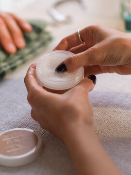 Manicurist using wax at work 