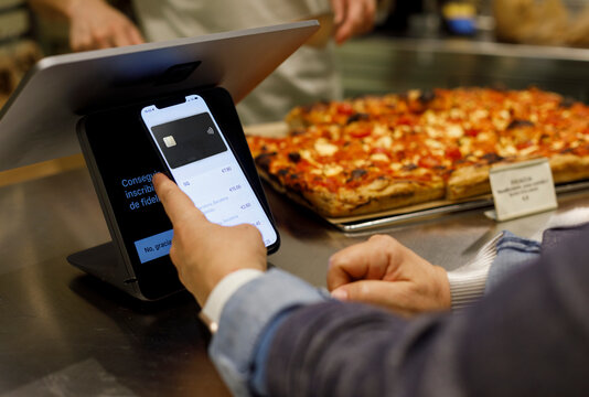 Customer Using smartphone for Payment at Local Bakery