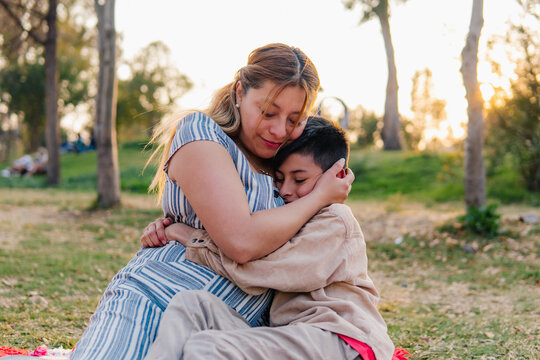 Mother and son hugging in park
