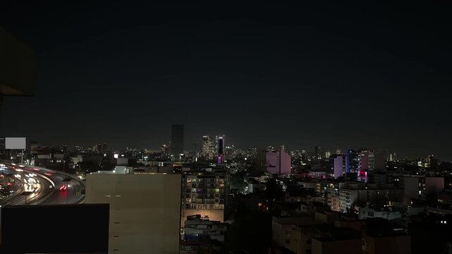Urban night scene with skyscrapers and motion blur traffic jam in Mexico city lock down camera