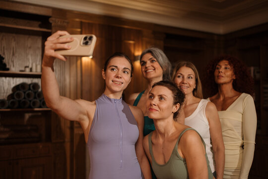Women take selfies on a mobile phones after sports