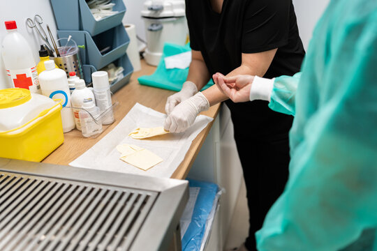 Veterinary surgeon preparing sterile gloves for operation