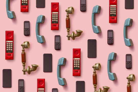 Vintage and modern phones and handsets arranged on pink backgrou