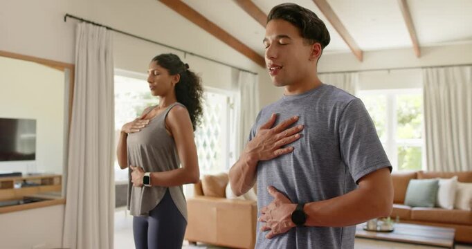 African American couple starting slow breathing at home with hands on chest and belly to relax