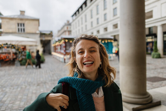 Happy woman laughing enjoying festive at Christmas market