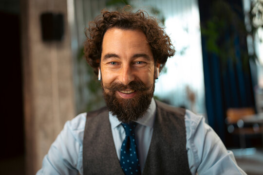 Man with beard smiling 
