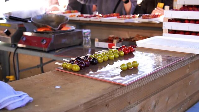 Preparation of Grape Tanghulu, Traditional Candied Fruit Skewers with Glass-like Sugar Coating at Street Food Stall