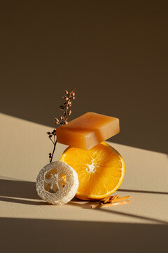 A harmonious composition of natural elements: soap, orange, and loofah