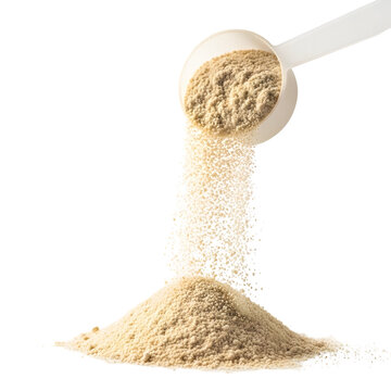 Beige protein powder being scooped and poured onto dark surface