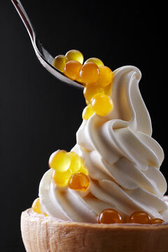Closeup of coconut ice cream and syrup-filled boba.