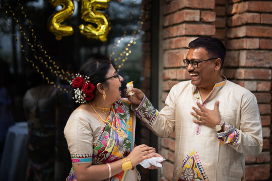 Middle aged Indian couple celebrating 25th anniversary looking happy