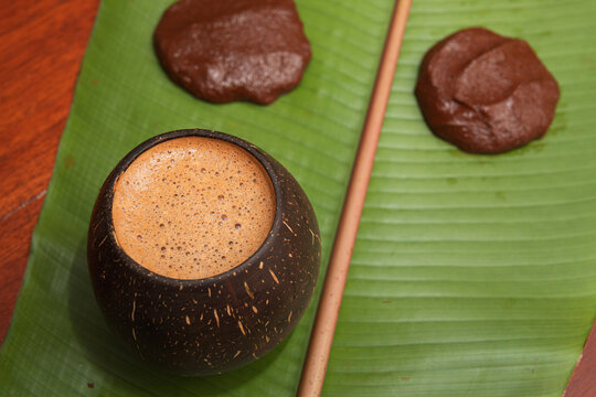 Chocolate drink with rich cacao elements over a banana leaf