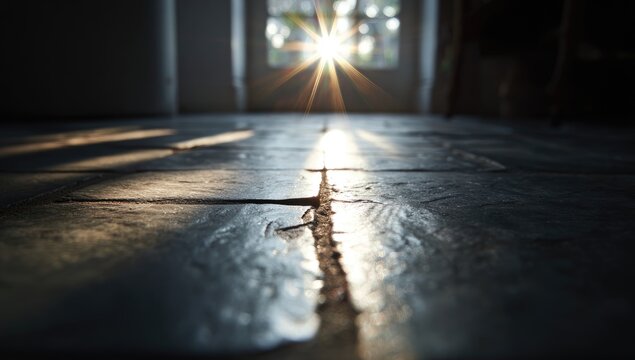 Low-angle view of a tiled floor with sunlight streaming through a window