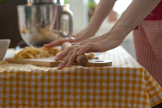 Woman hands rolling fresh pasta dough