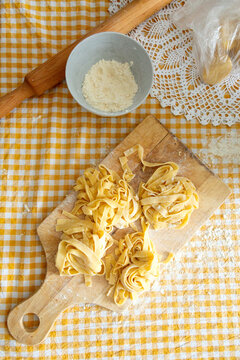 Fresh handmade pasta tagliatelle on a wooden board